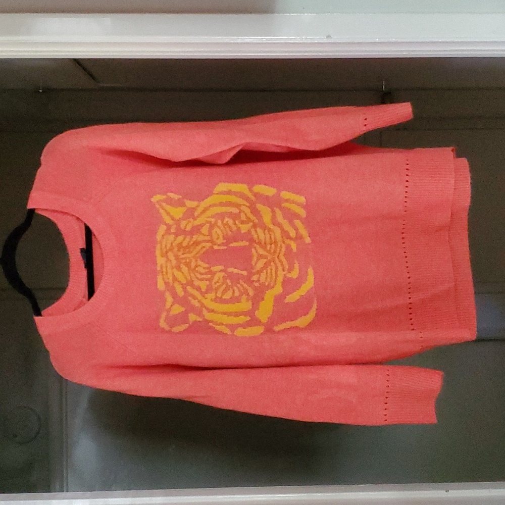 Bright pink sweater with yellow tiger.  Stretchy and comfy.  Never worn.